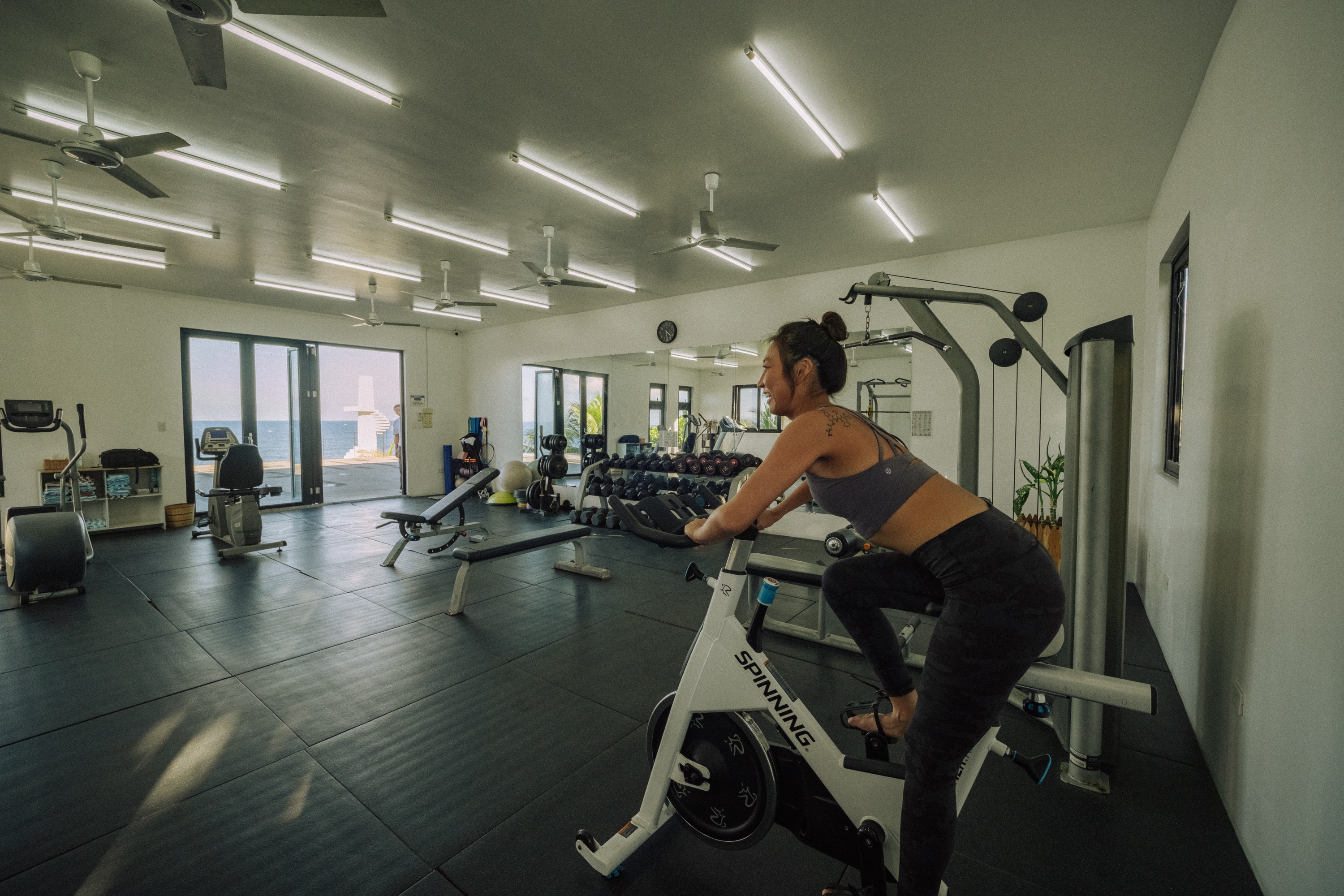Guest enjoying an ocean-view workout in the fitness center