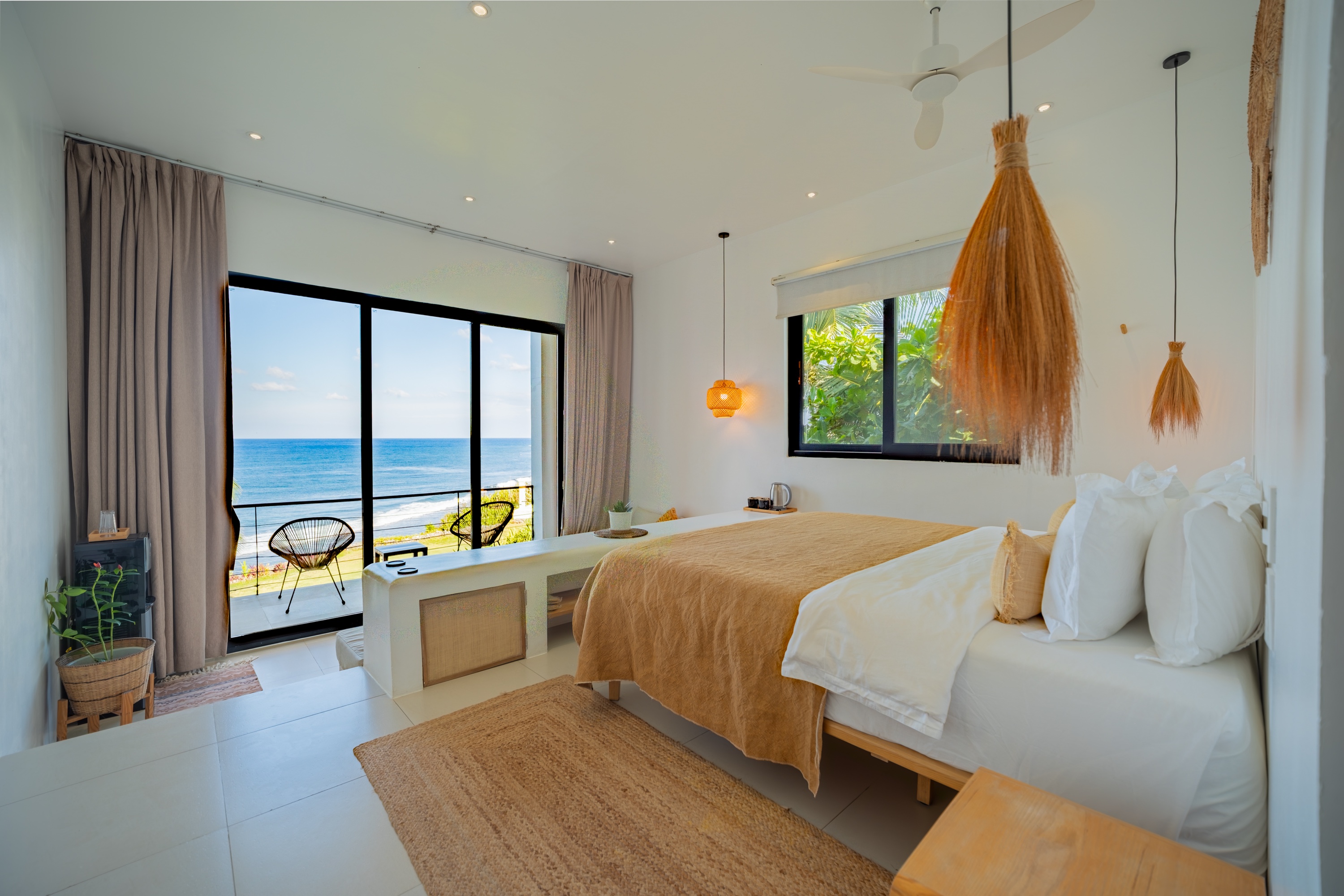 Ocean-view guest room with king bed and private balcony at Trogon’s Perch